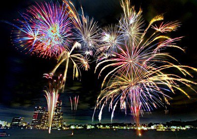 都会の夜景と調和する華やかな花火