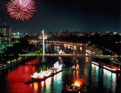 船のかがり火と花火が夜空を彩る