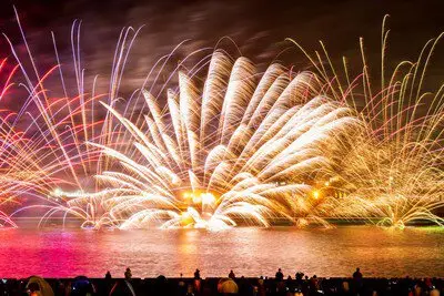 Gorgeous waterborne fireworks enveloping the night sky and sea