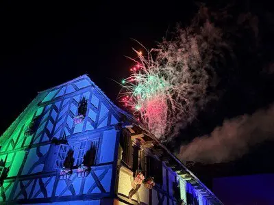 Fantastical summer fireworks blooming over exotic streetscapes